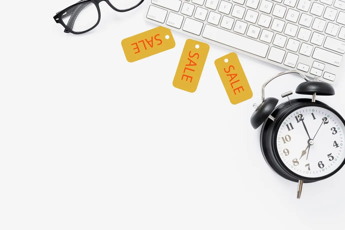 Top-down view of a desk with sale tags.
